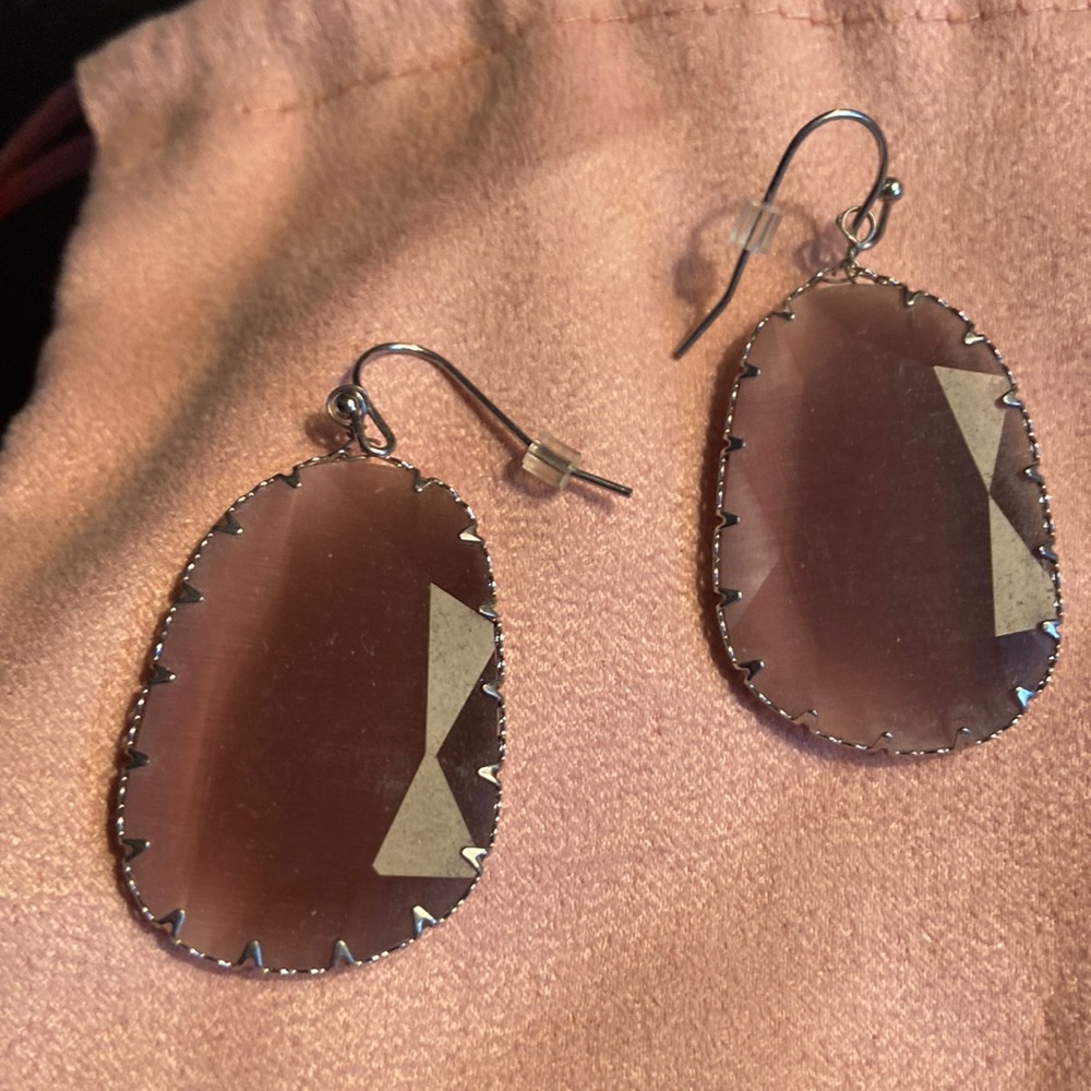 Pinkish purple silver trimmed earrings.